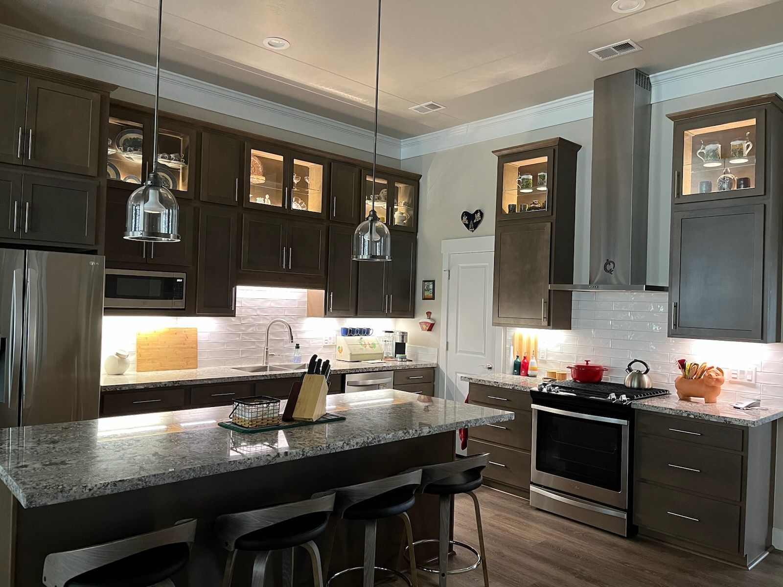 A kitchen with stainless steel appliances and granite counter tops.
