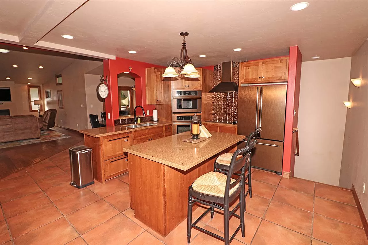 A kitchen with a large island and stainless steel appliances