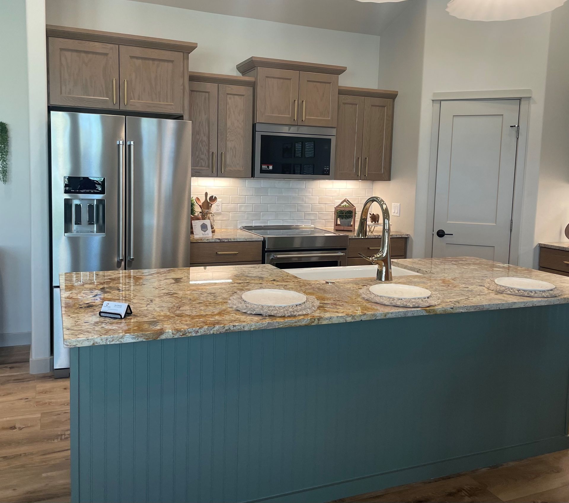 A kitchen with blue cabinets and stainless steel appliances