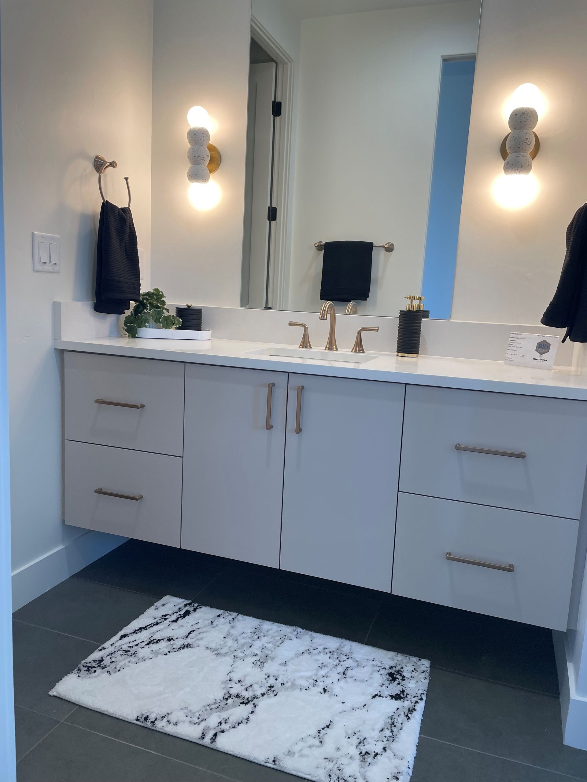 A bathroom with one sink and a large mirror