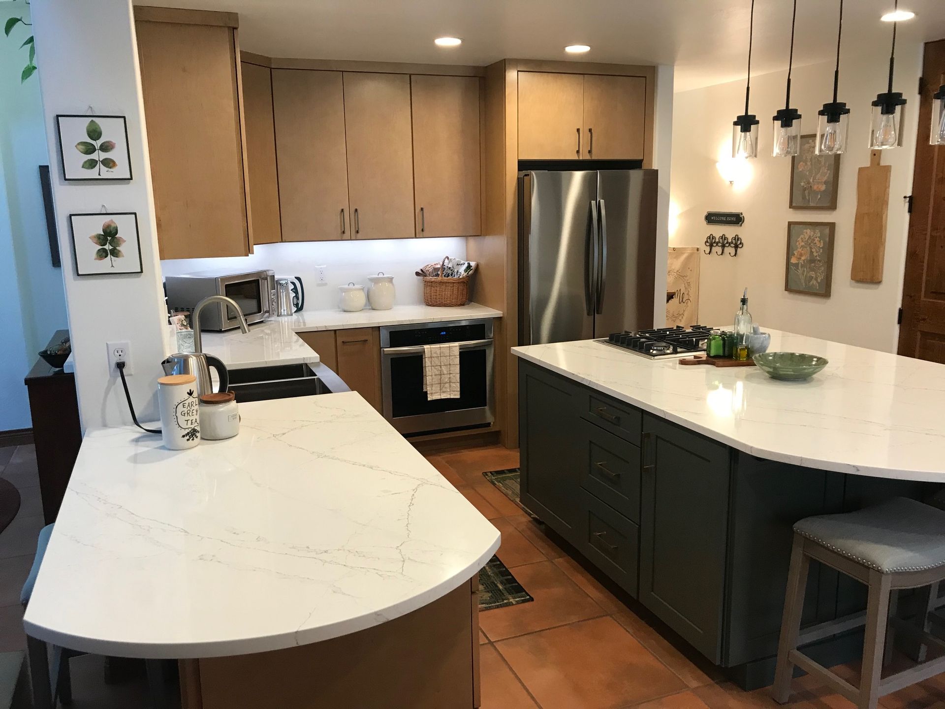 A kitchen with stainless steel appliances and a large island.