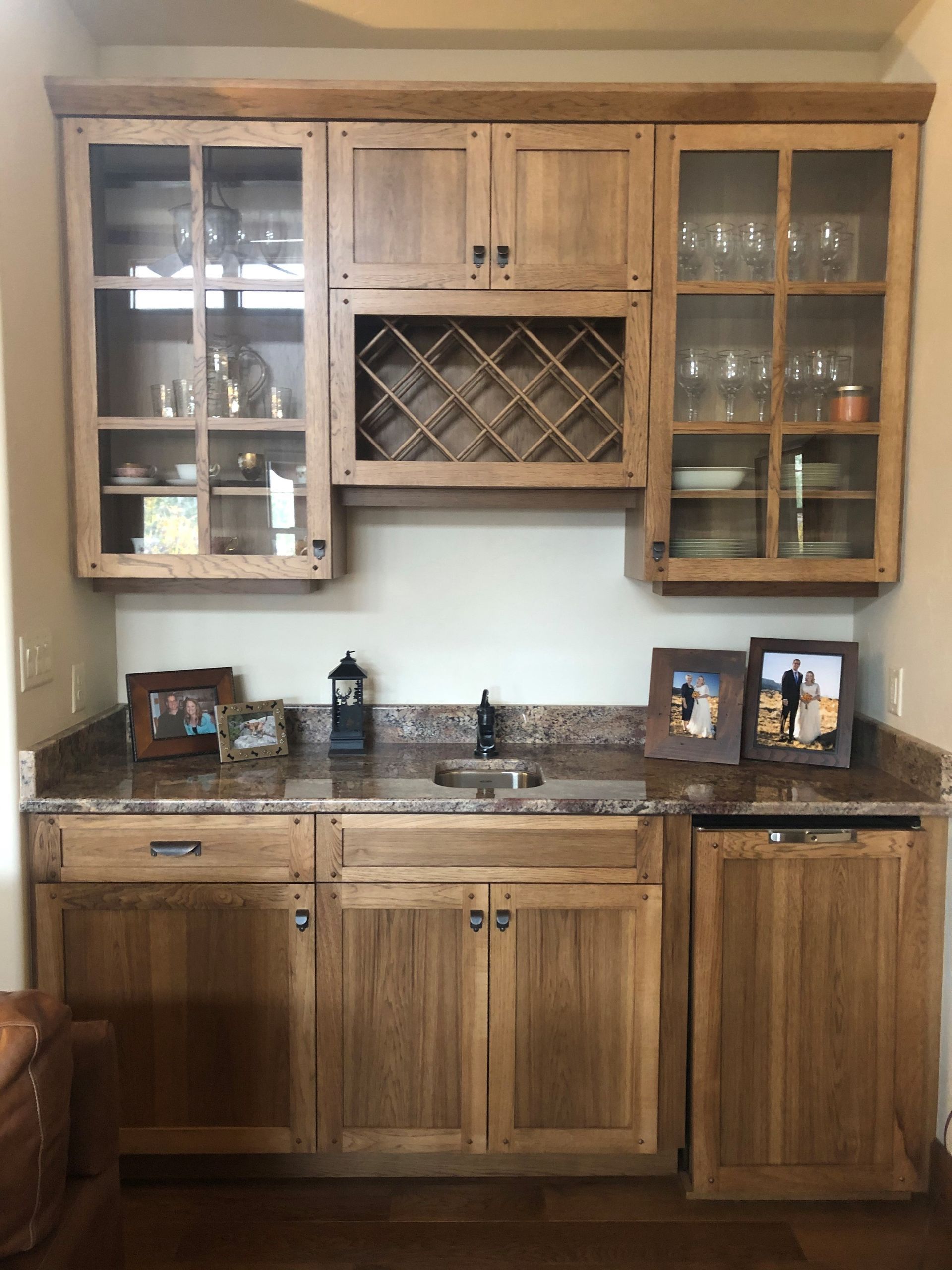 A kitchen with wooden cabinets and a wine rack