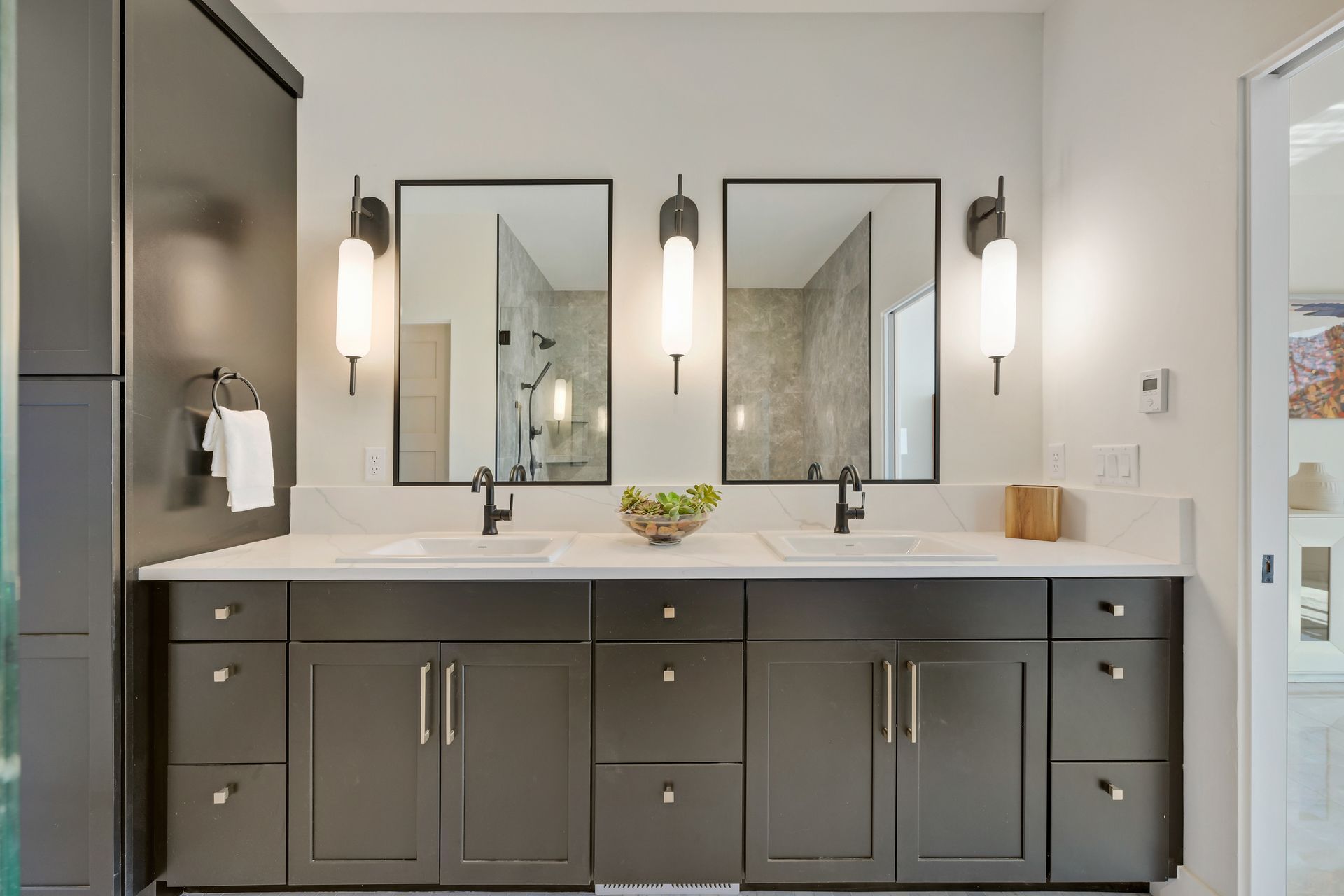 A bathroom with two sinks and two mirrors