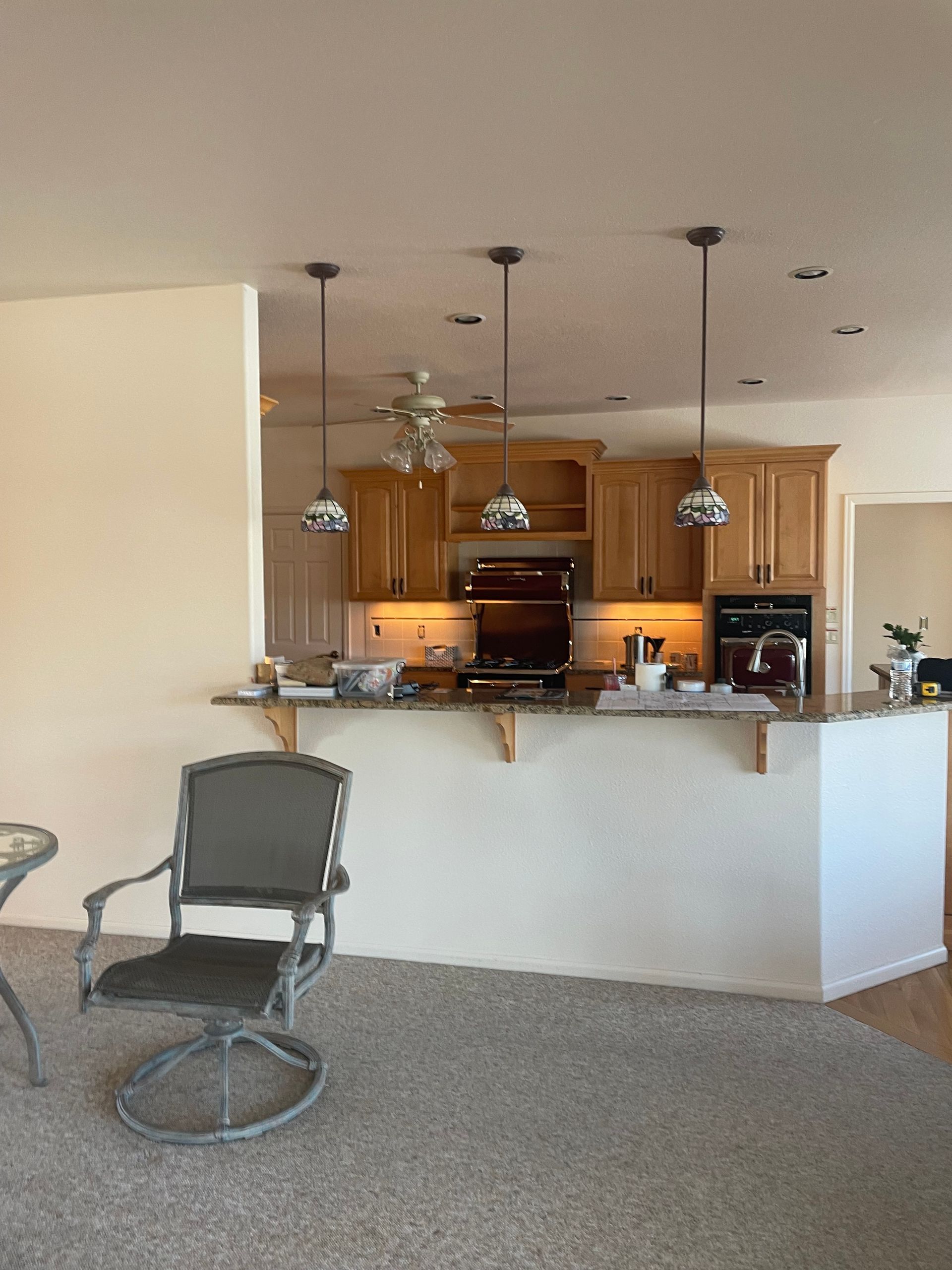 A kitchen with a chair and a table in it