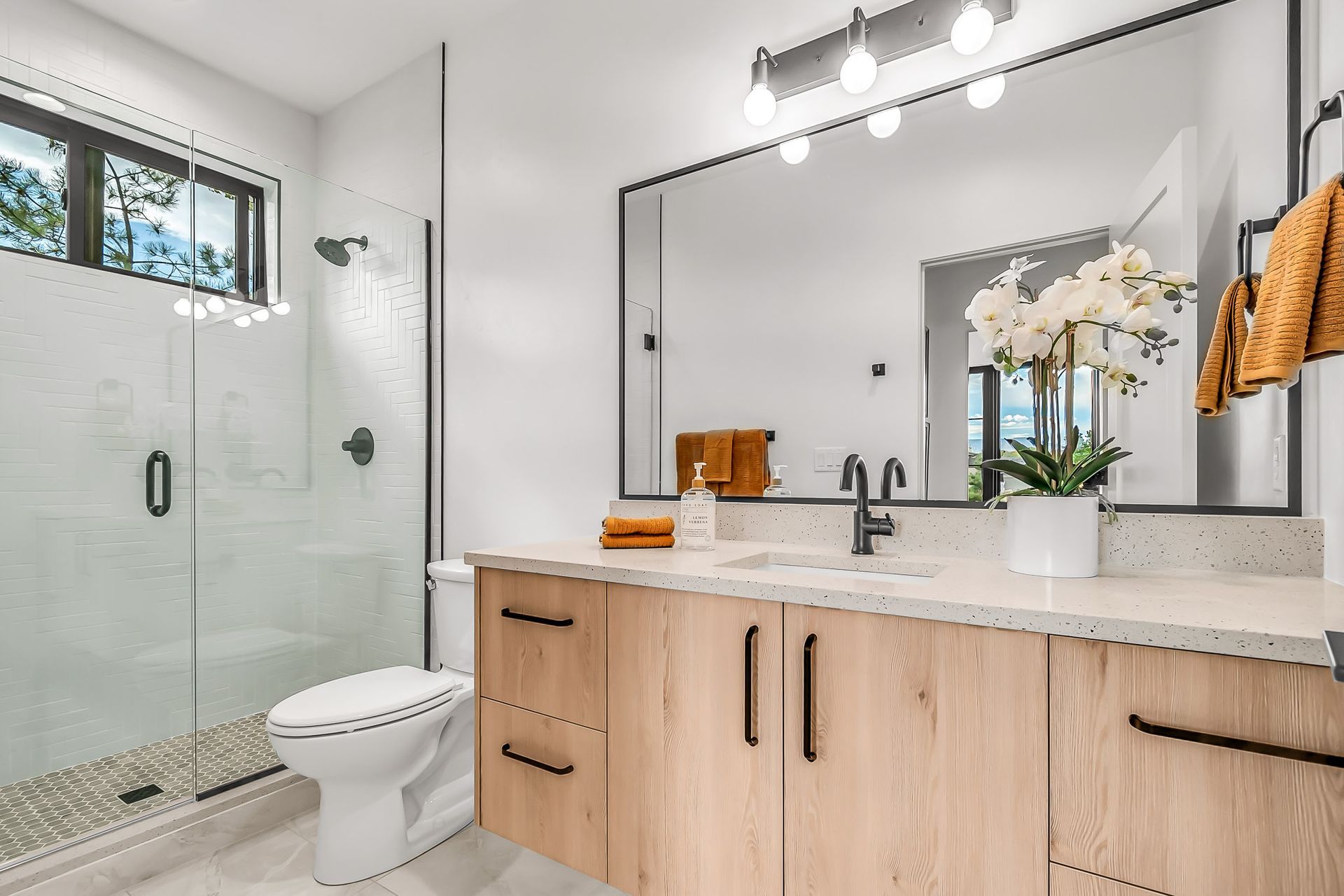 a bathroom with a toilet , sink , and mirror .