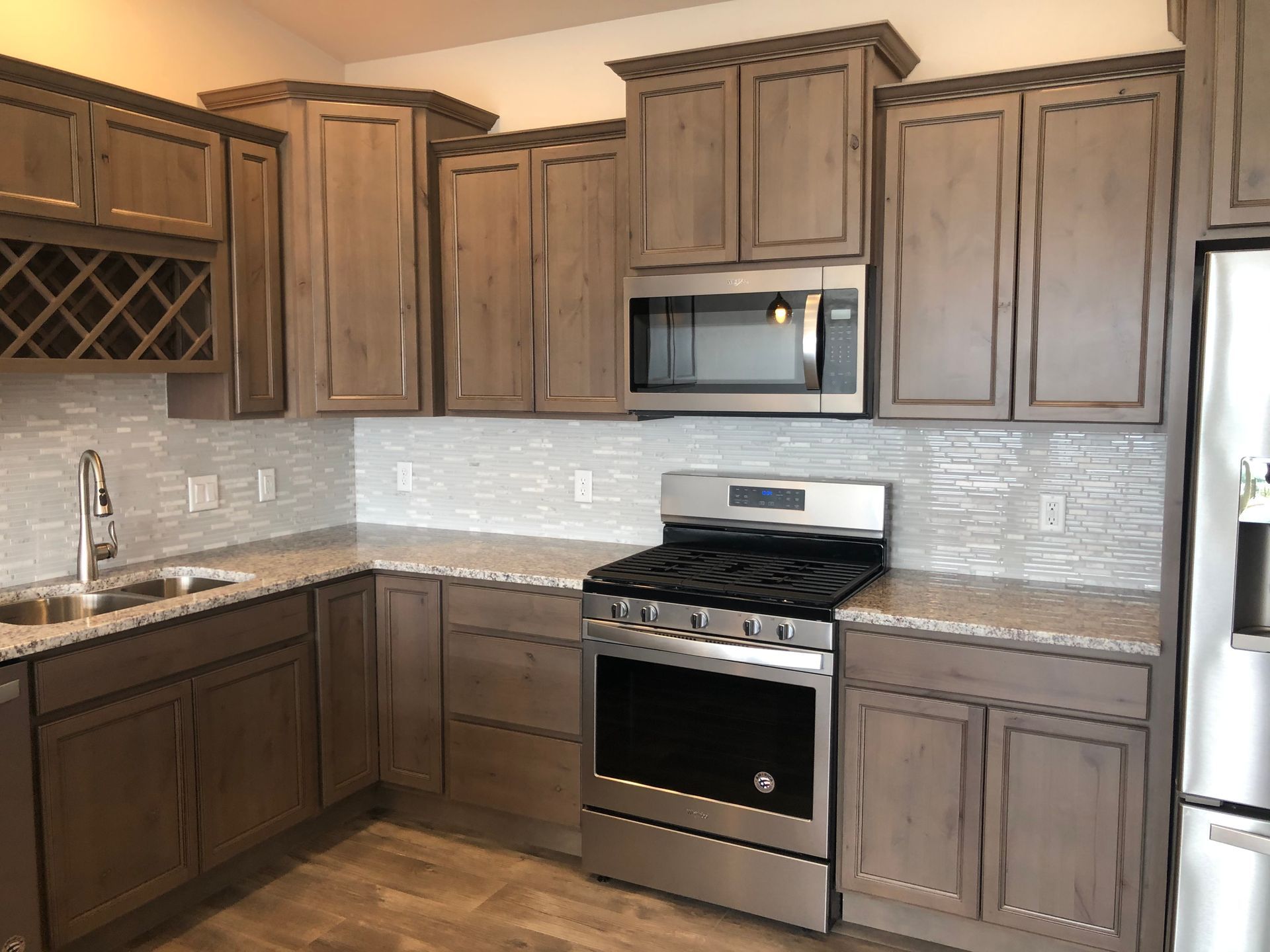 a kitchen with stainless steel appliances and wooden cabinets .
