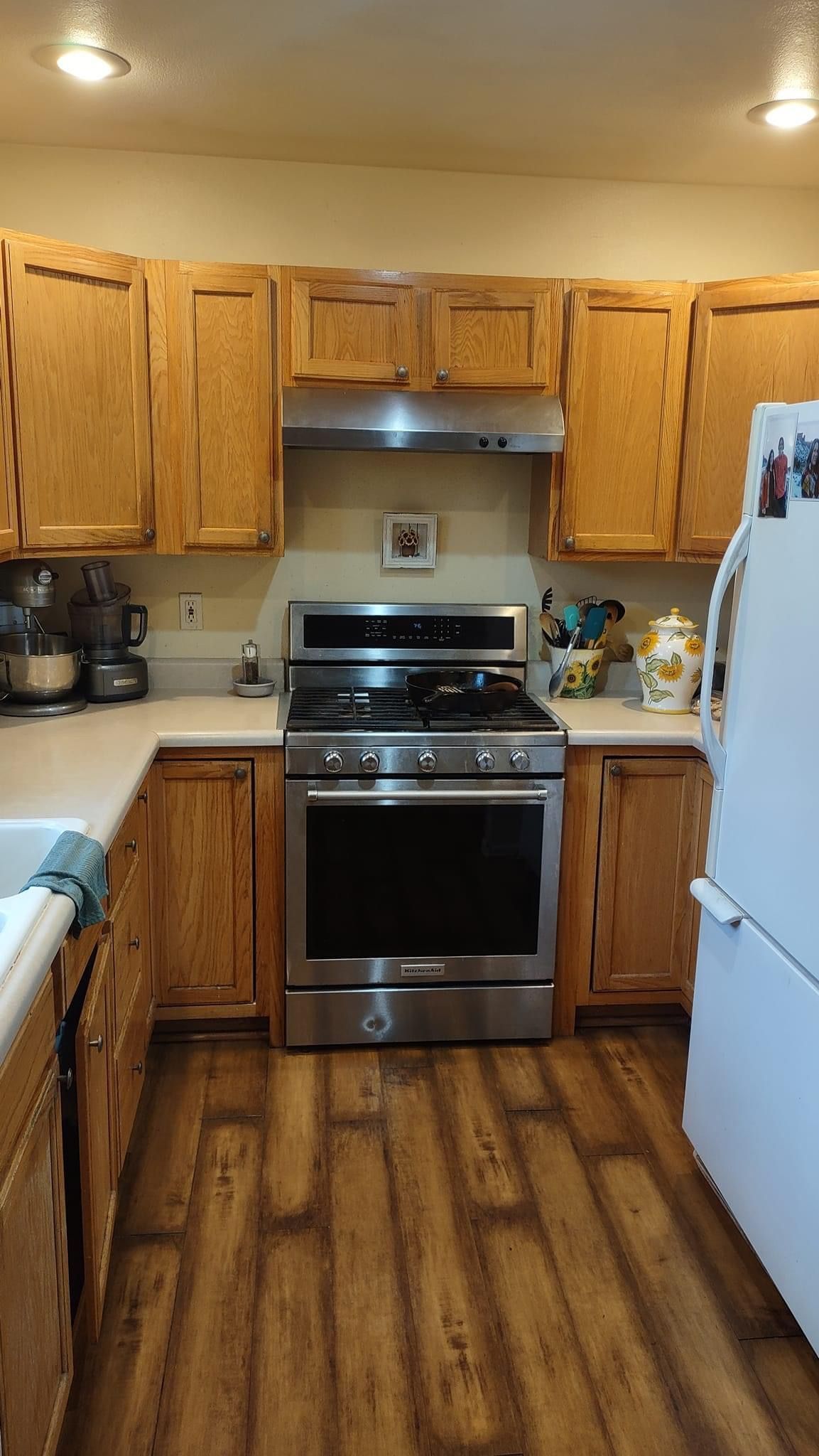 A kitchen with stainless steel appliances and wooden cabinets