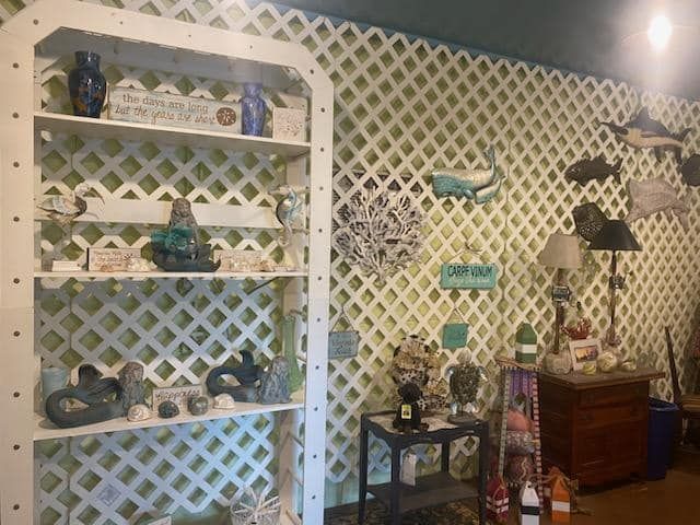a room with a lattice wall and a shelf with decor