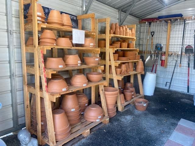 a bunch of pots on shelves