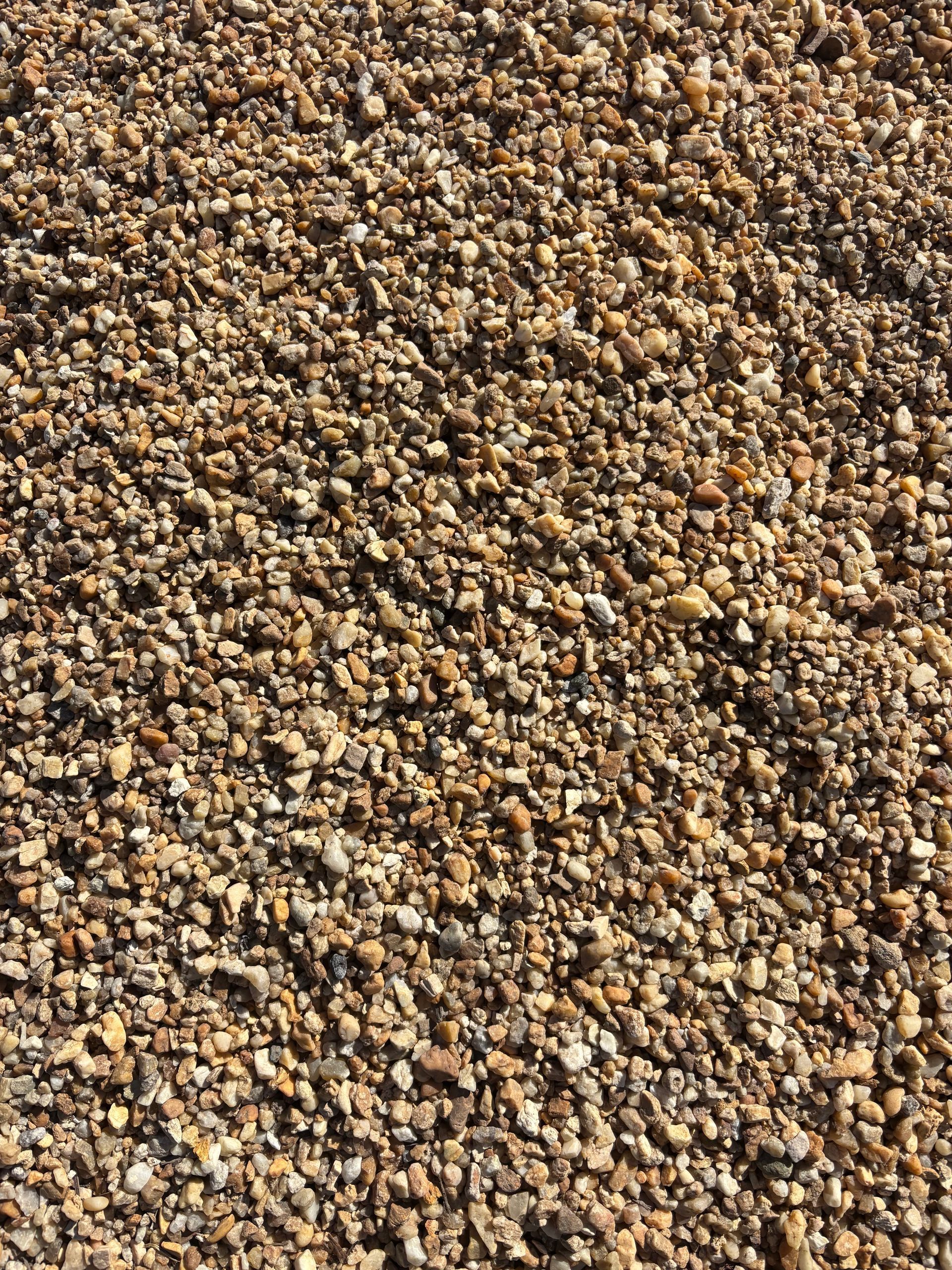 Close-up of small brown and tan pebbles covering the ground