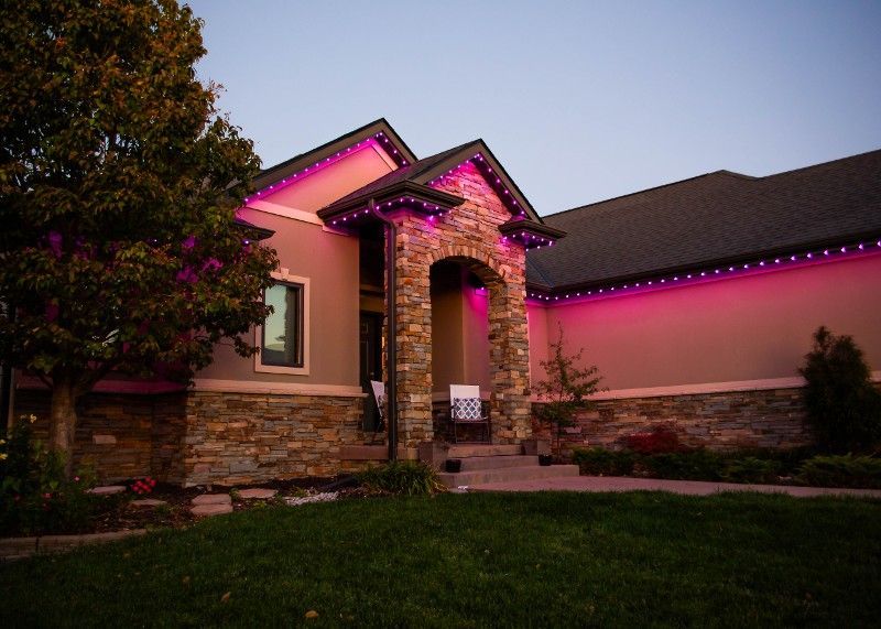 A house with purple lights on the side of it