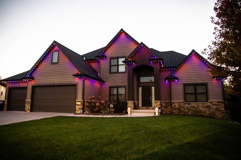 A large house with purple lights on the roof