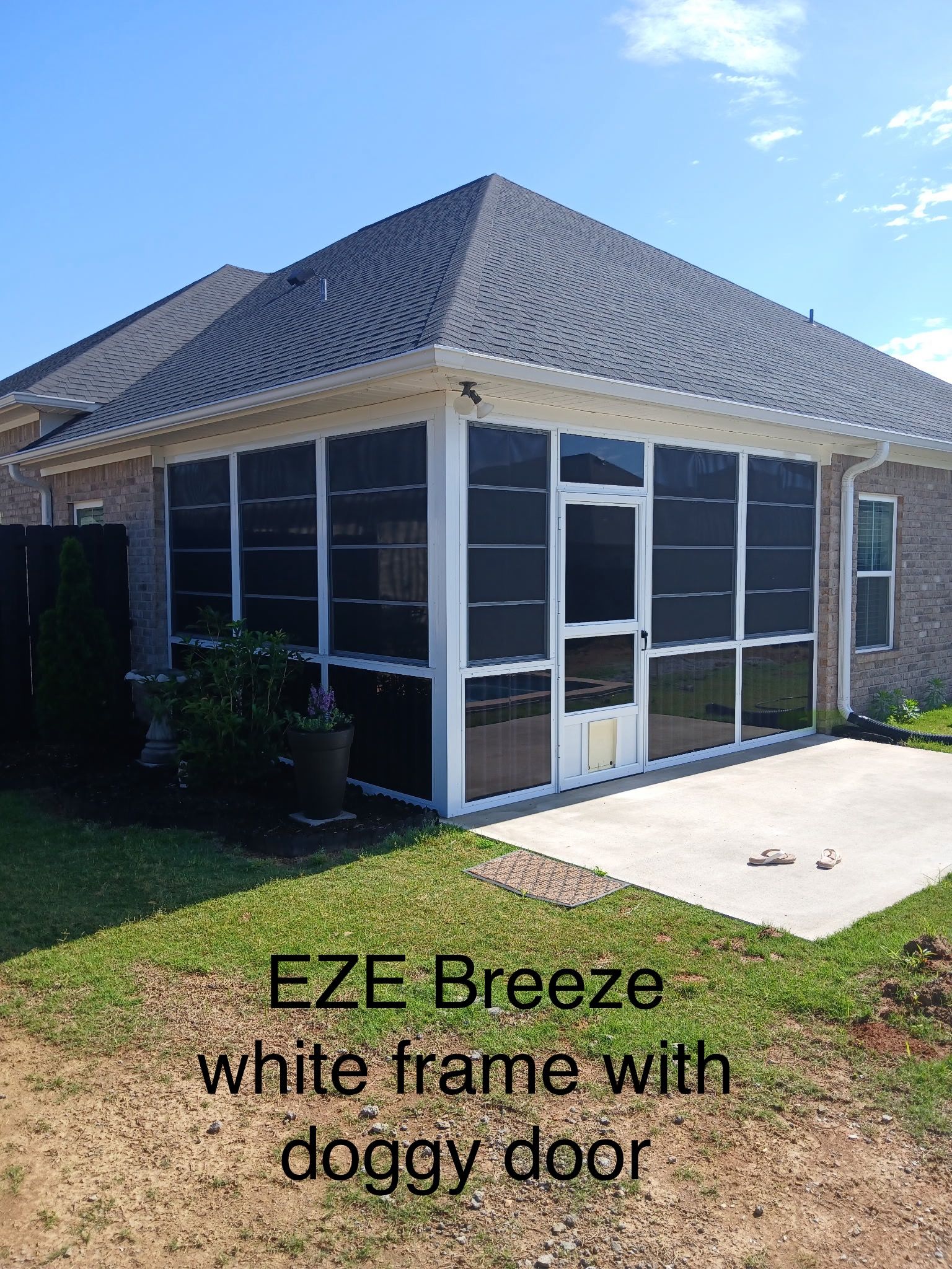 EZE Breeze white-frame screened patio with doggy door and tiled roof