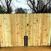 Wooden fence with closed gate.