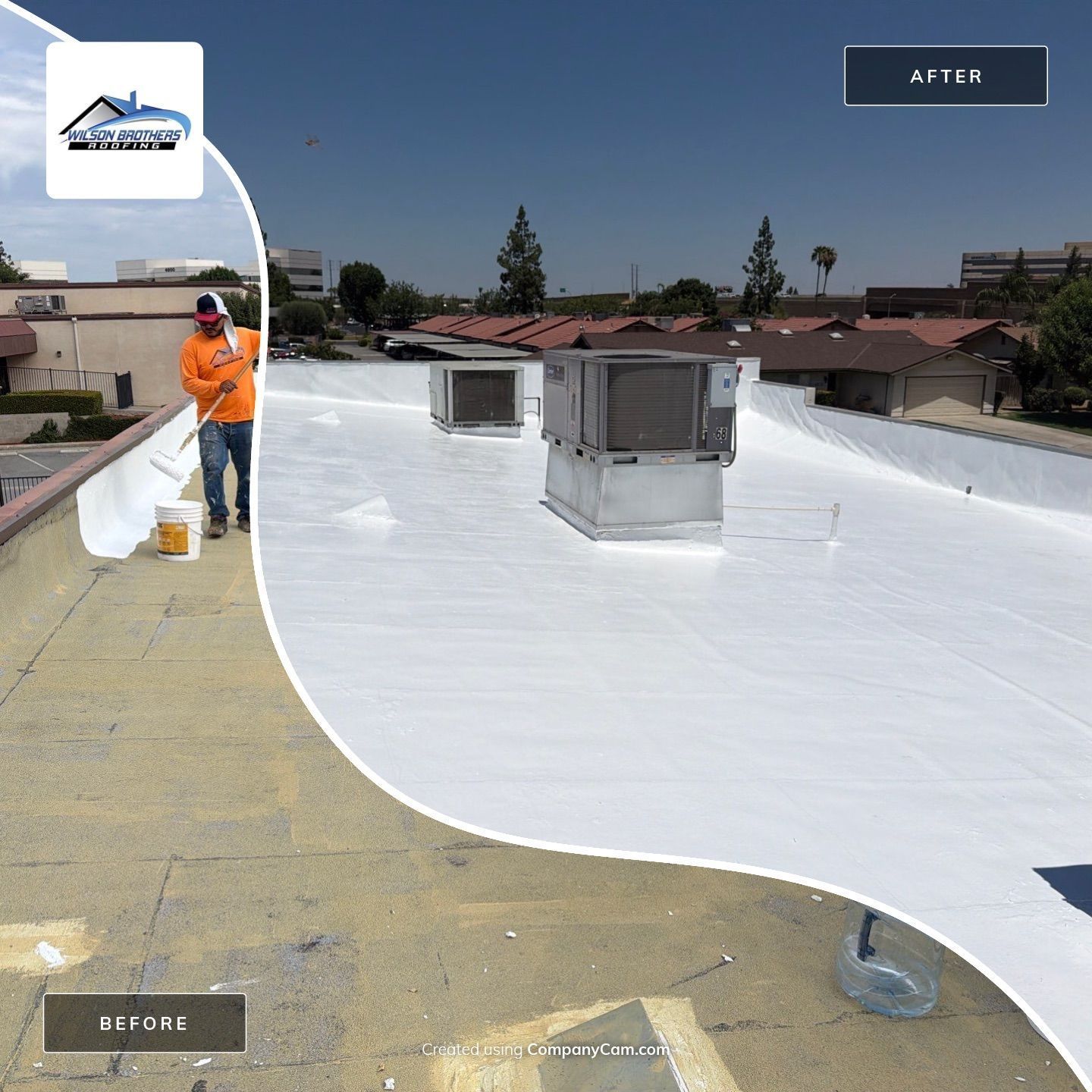 Worker applying white roof coating on flat rooftop with vents under a clear blue sky