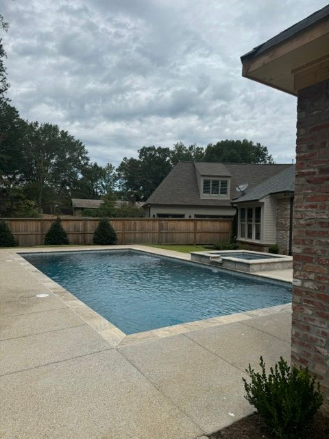 A large swimming pool in the backyard of a house