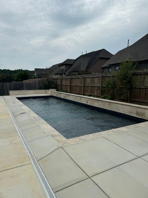 A large swimming pool in the backyard of a house