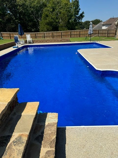 A large blue swimming pool with stairs leading to it
