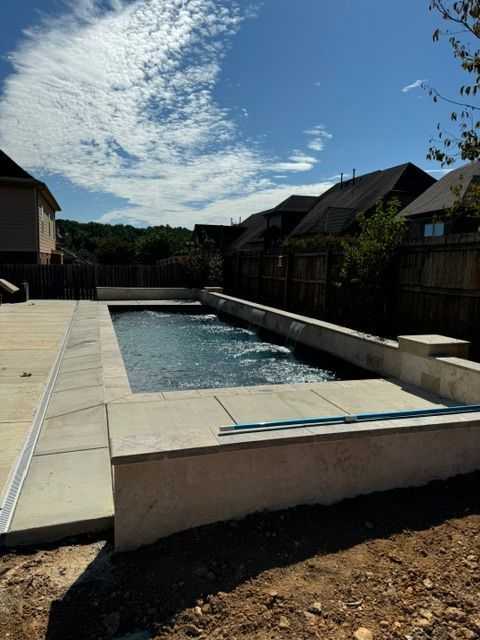 A large swimming pool in the backyard of a house