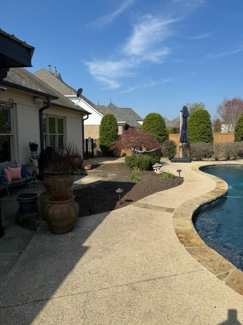 There is a large swimming pool in the backyard of a house.