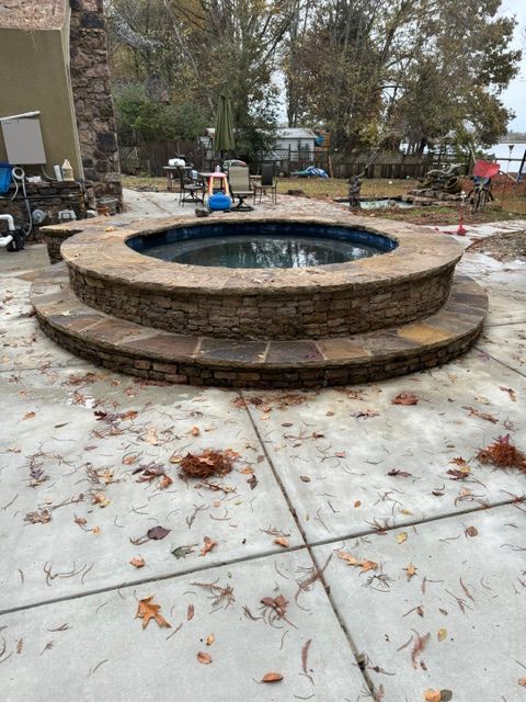 A hot tub is sitting on top of a concrete patio.