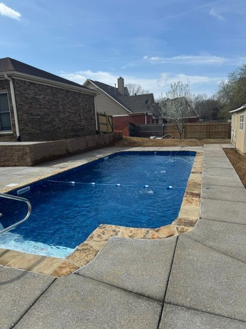 A large swimming pool in the backyard of a house