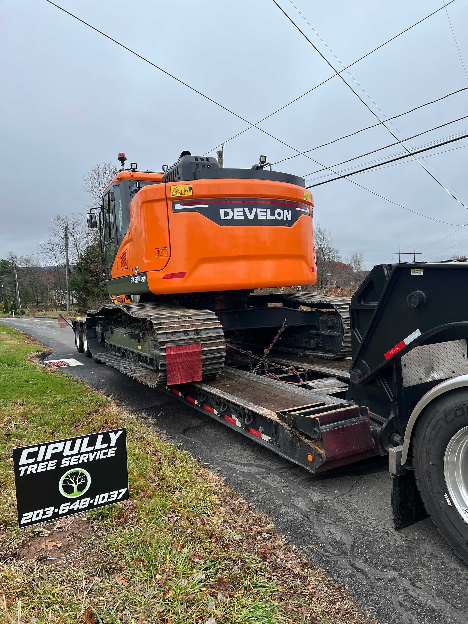 orange excavator on a flatbed trailer