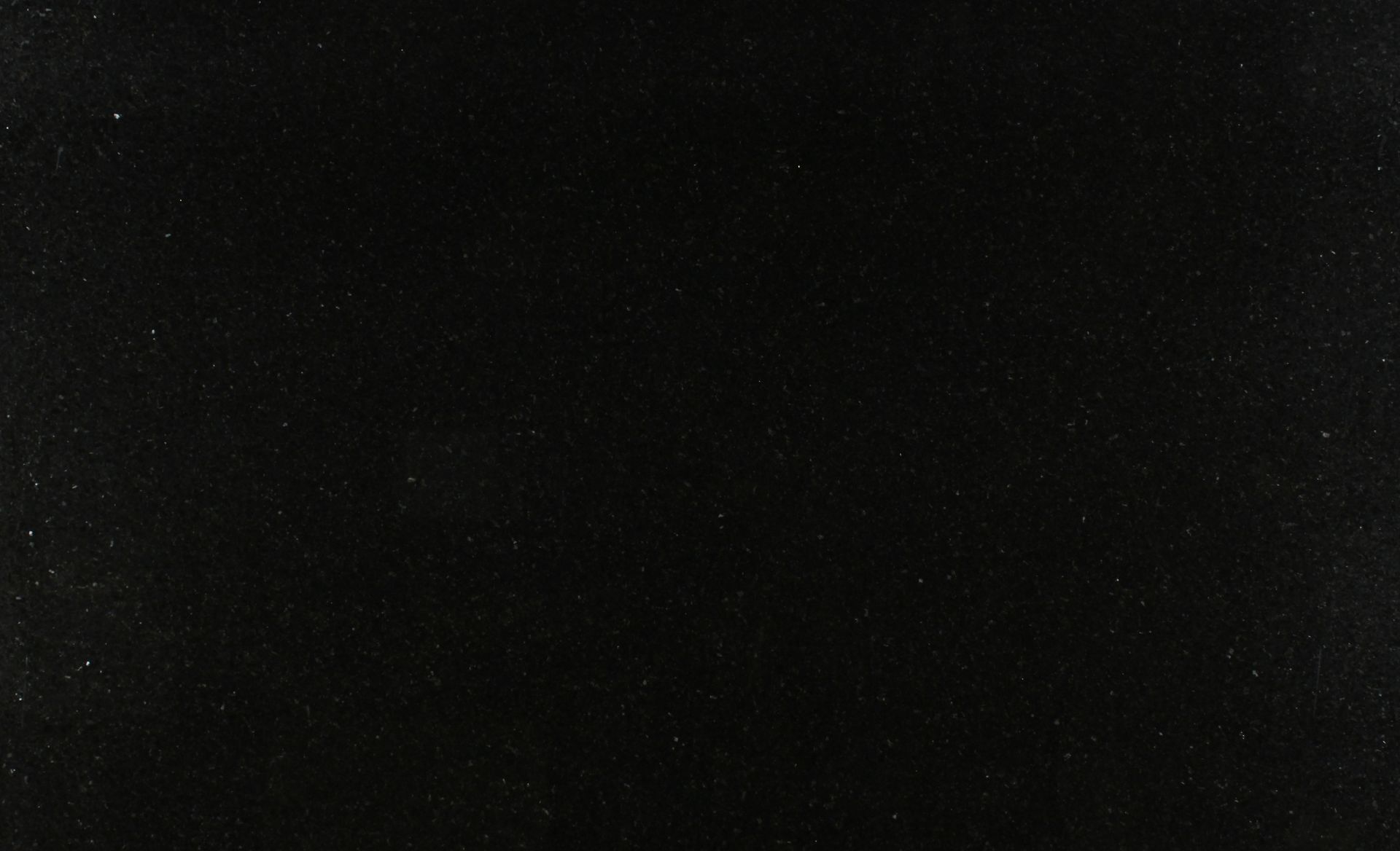 Dark, nearly black image with faint white specks, like a dim starry sky or noisy texture.