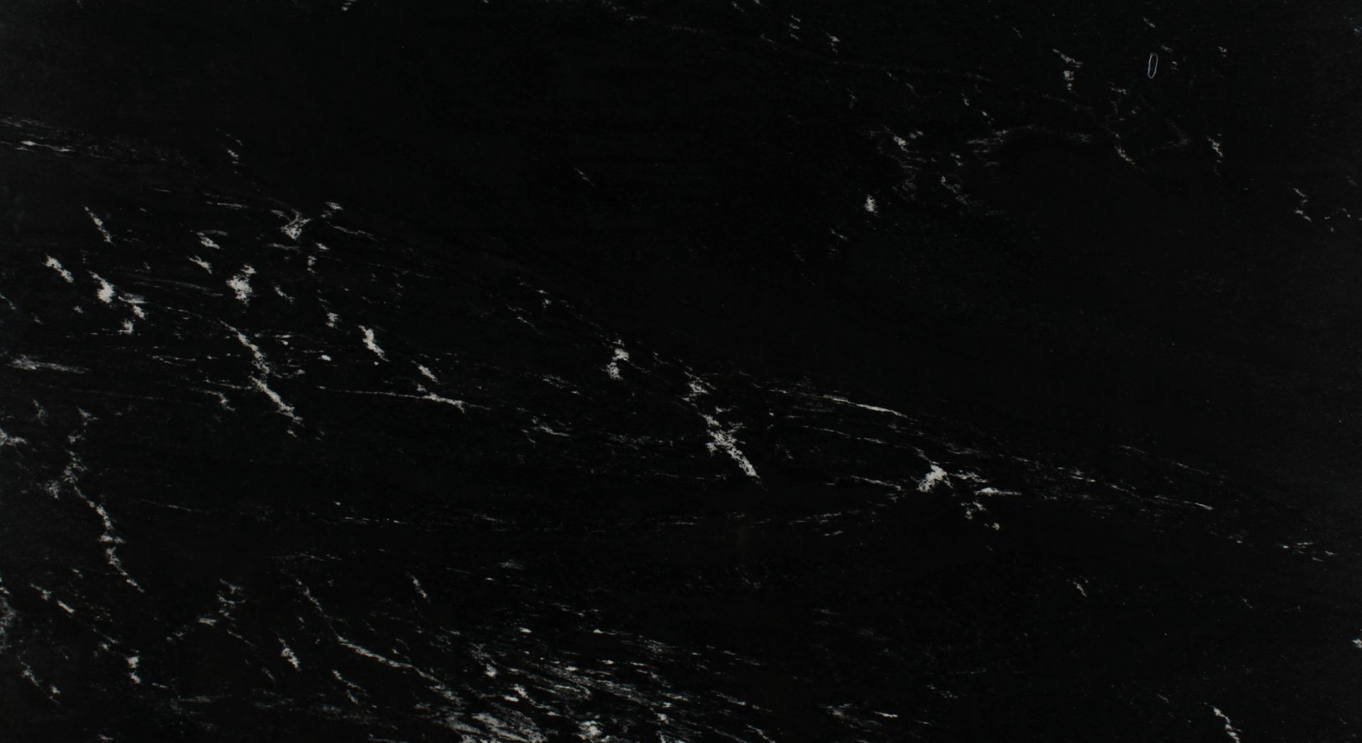Dark, nearly black abstract background with scattered white specks and streaks like scratches or stars