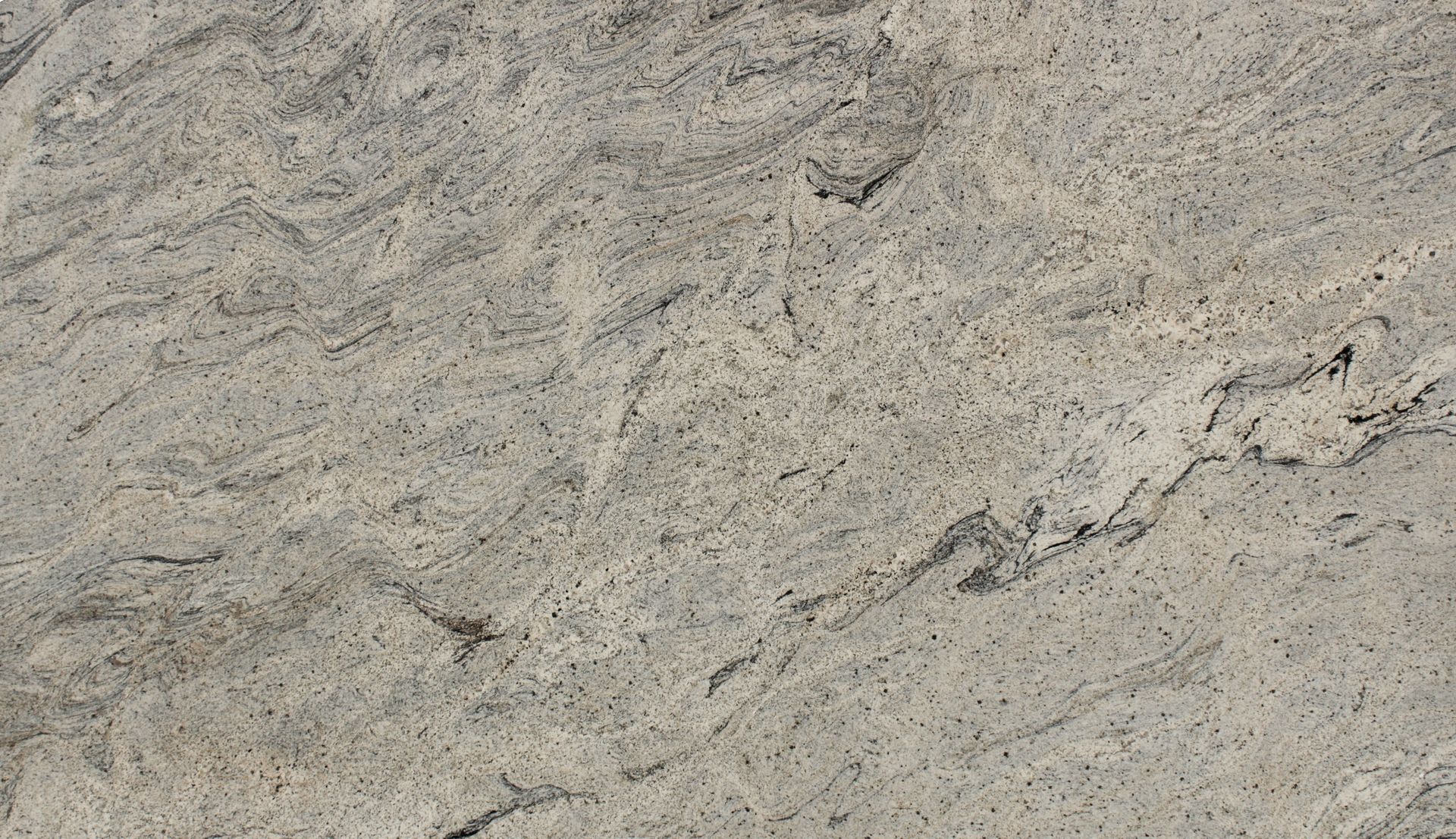 Close-up of light gray textured stone with subtle dark veining and speckled surface