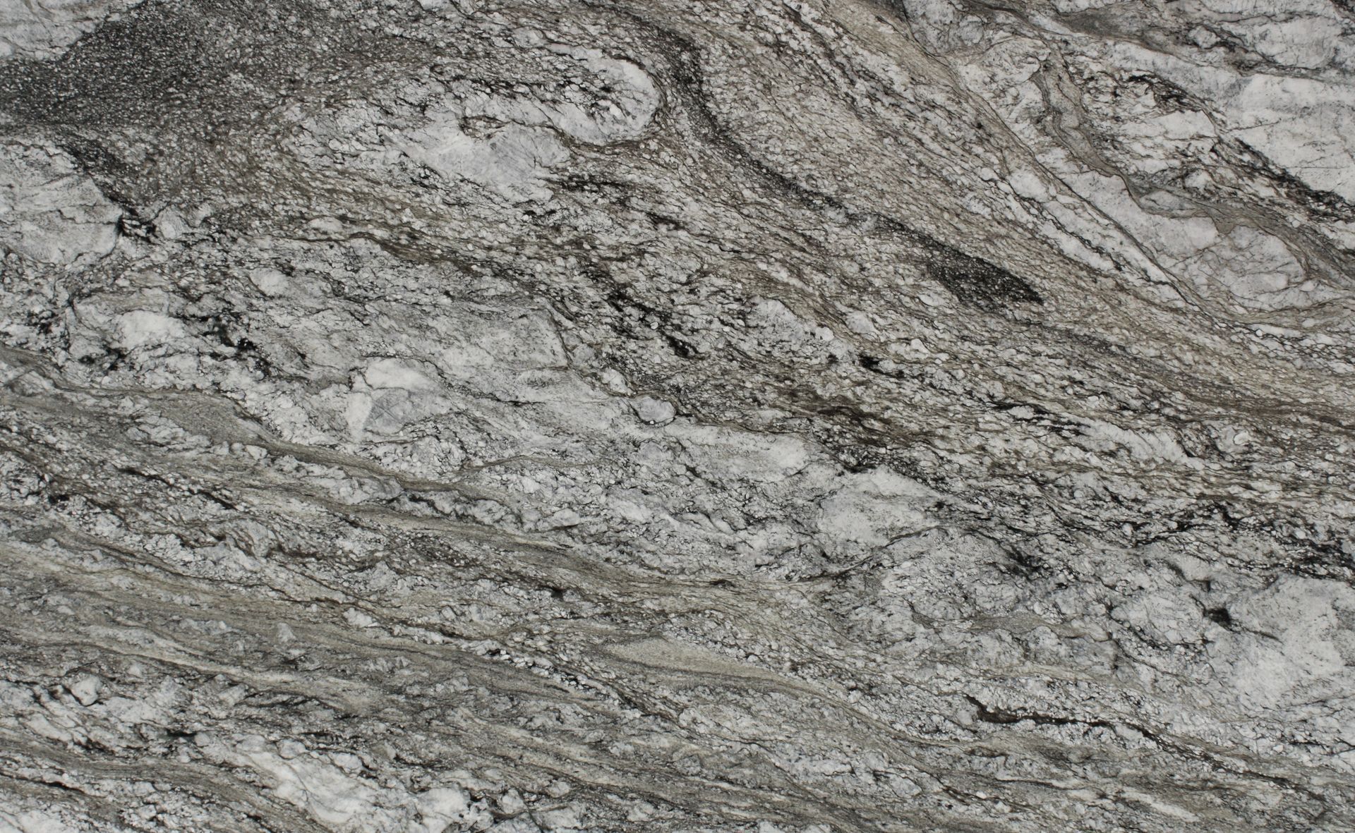 Gray and white marbled stone surface with dark veining and wavy texture