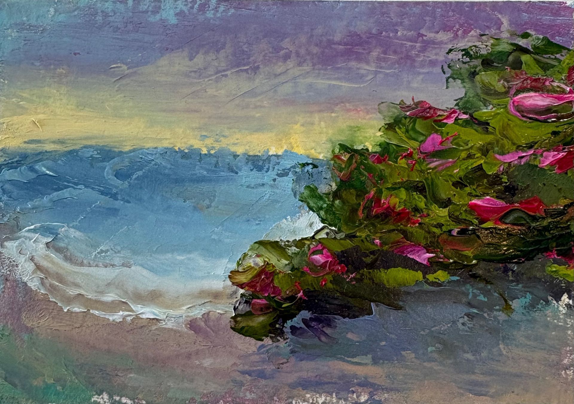 An impressionist oil painting of a blue wave crashing against a shore with vibrant green bushes and pink flowers.