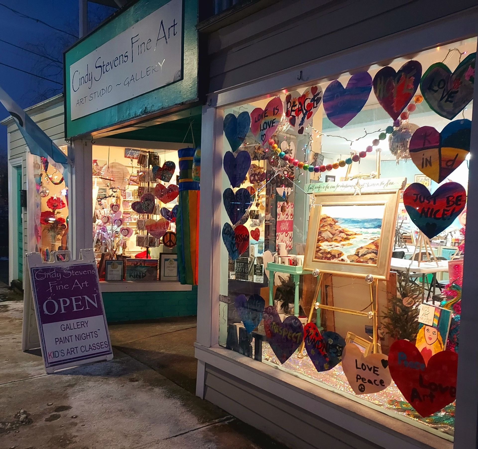 A store front with a sign that says love is open