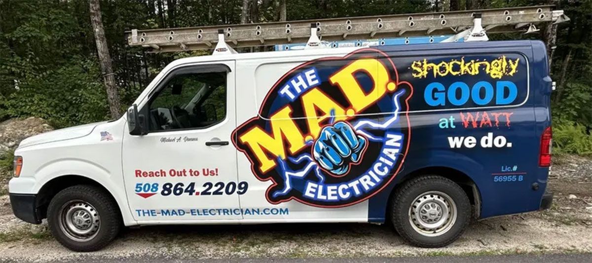 White electrician van with &ldquo;The MAD Electrician&rdquo; and &ldquo;Shockingly good work&rdquo; branding on the side.