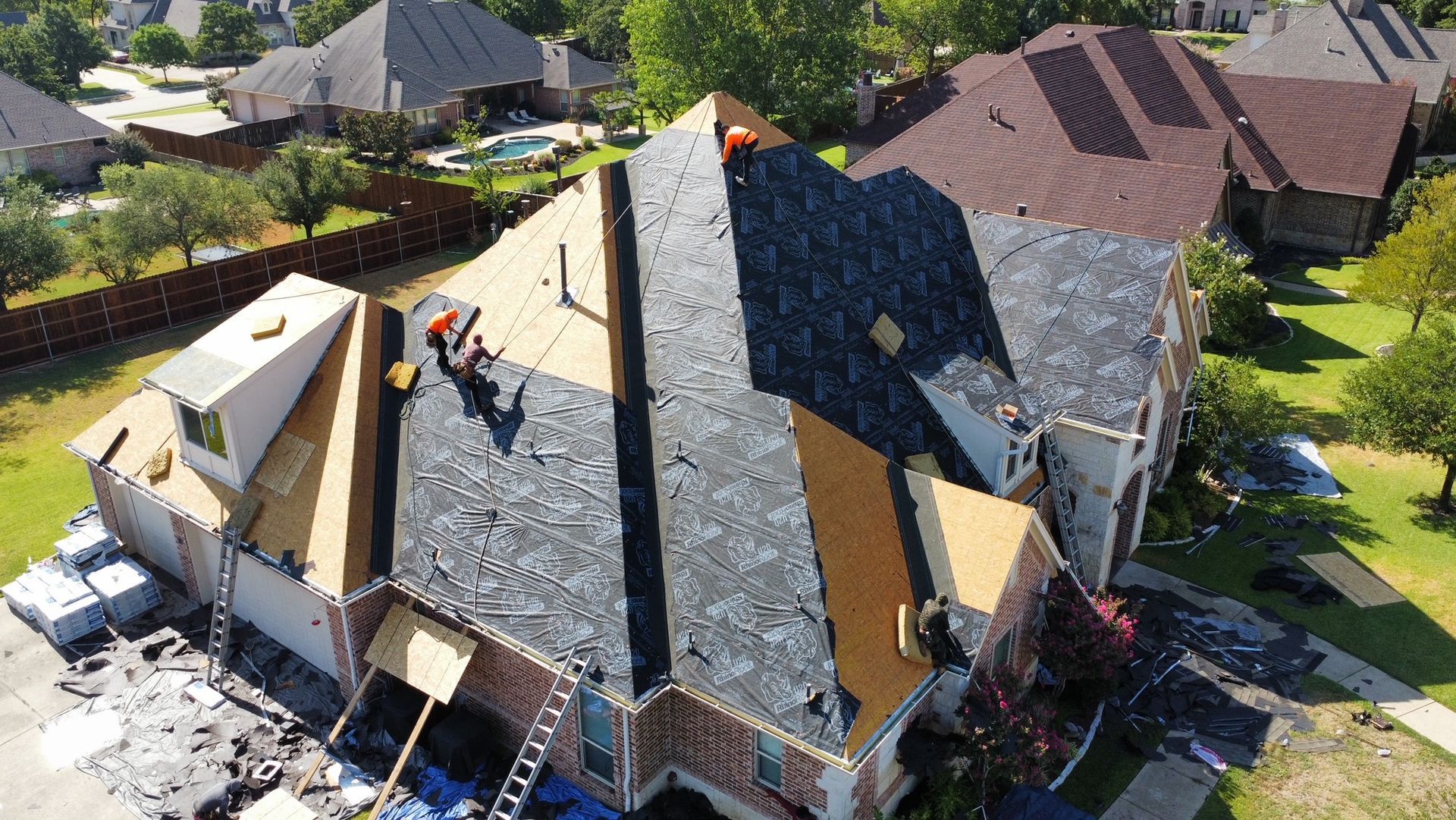An aerial view of a house being remodeled with a new roof.