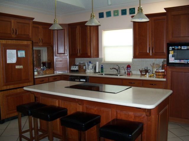 A kitchen with a large island and stools