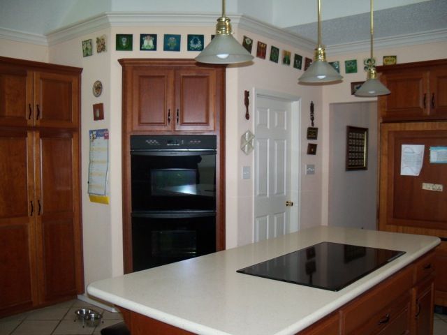 A kitchen with a large island and a stove top oven