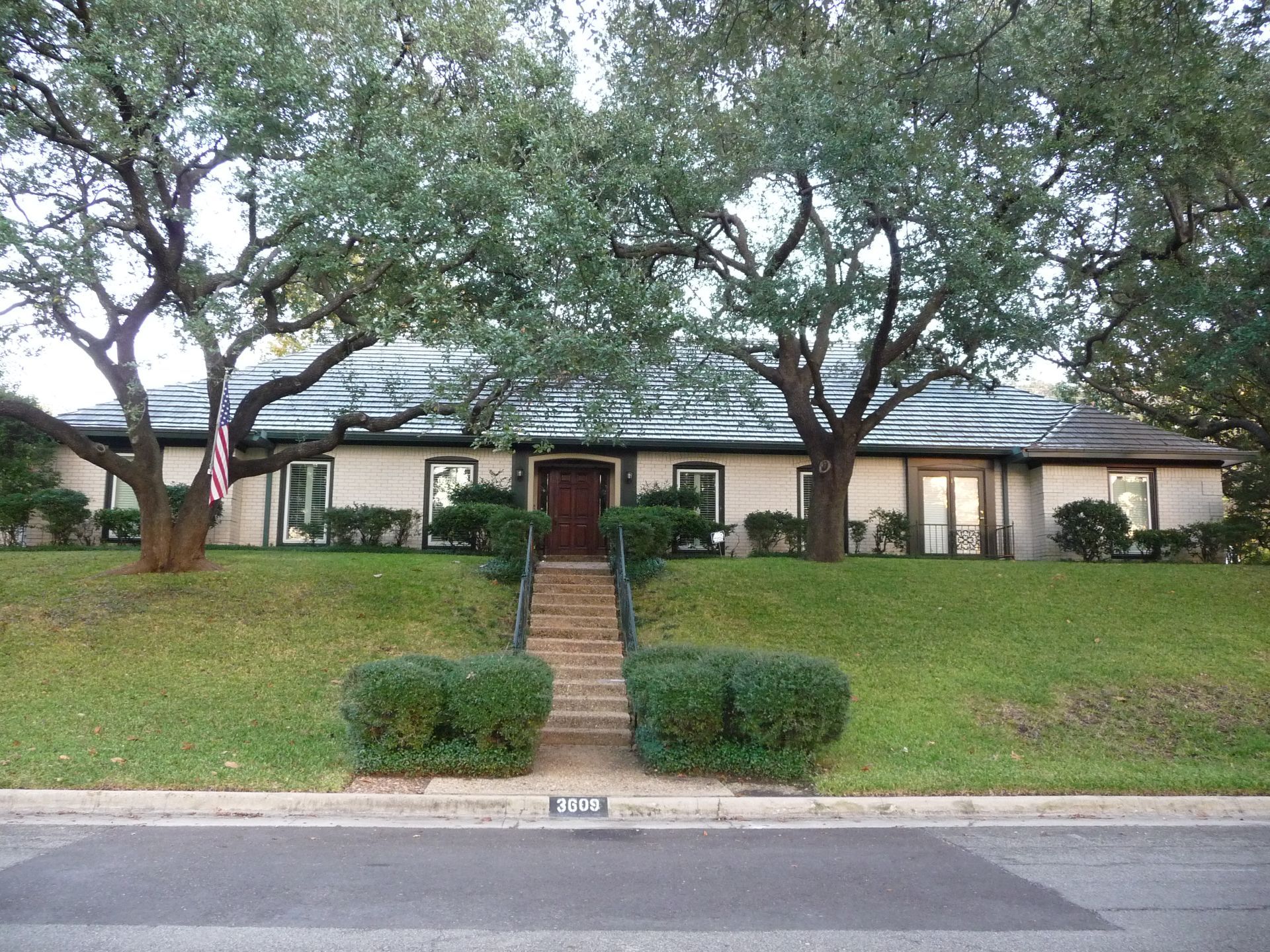 A large house with stairs leading up to the front door