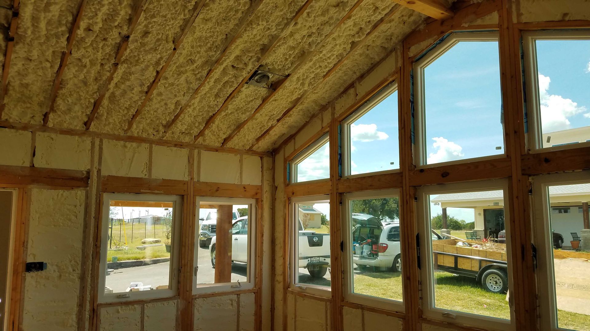 A room with a lot of windows and foam on the ceiling.