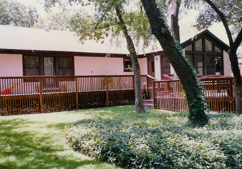 A house with a large deck in front of it