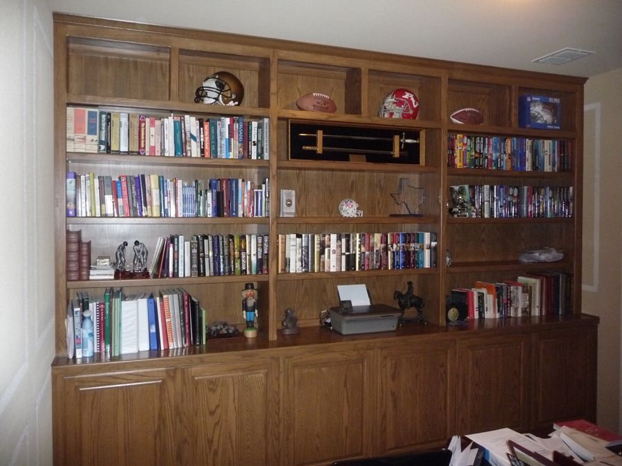 A large wooden bookshelf with lots of books on it