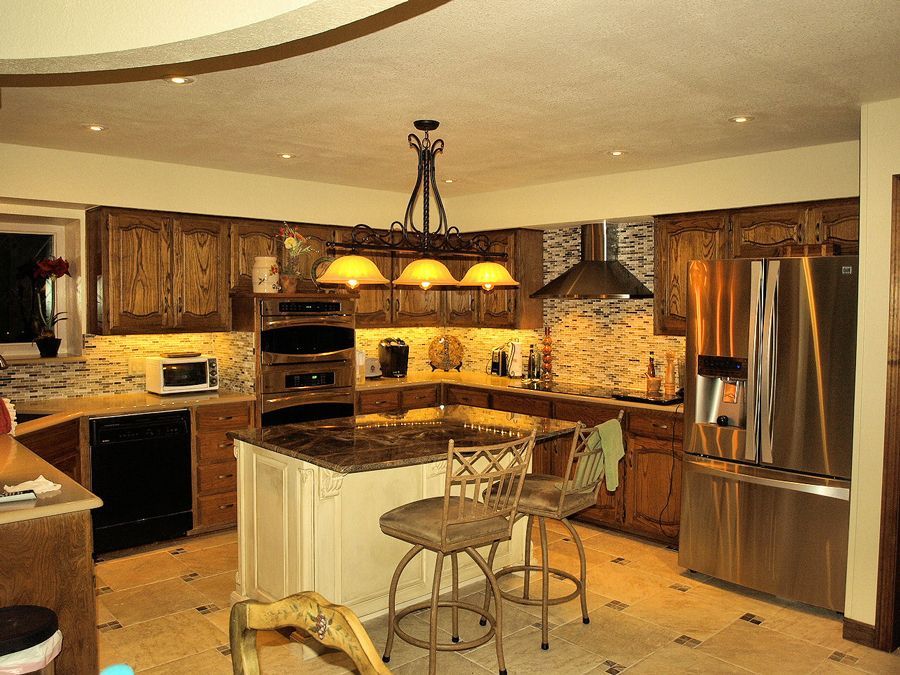A kitchen with stainless steel appliances and a large island