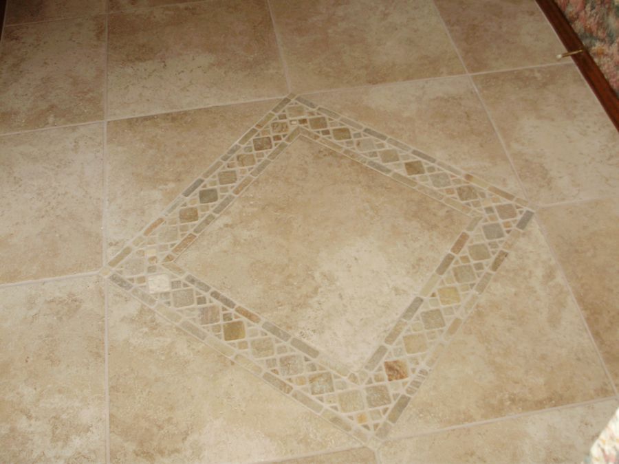 A tiled floor with a square design on it.