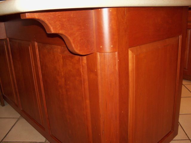 A close-up of a wooden cabinet with a white counter top