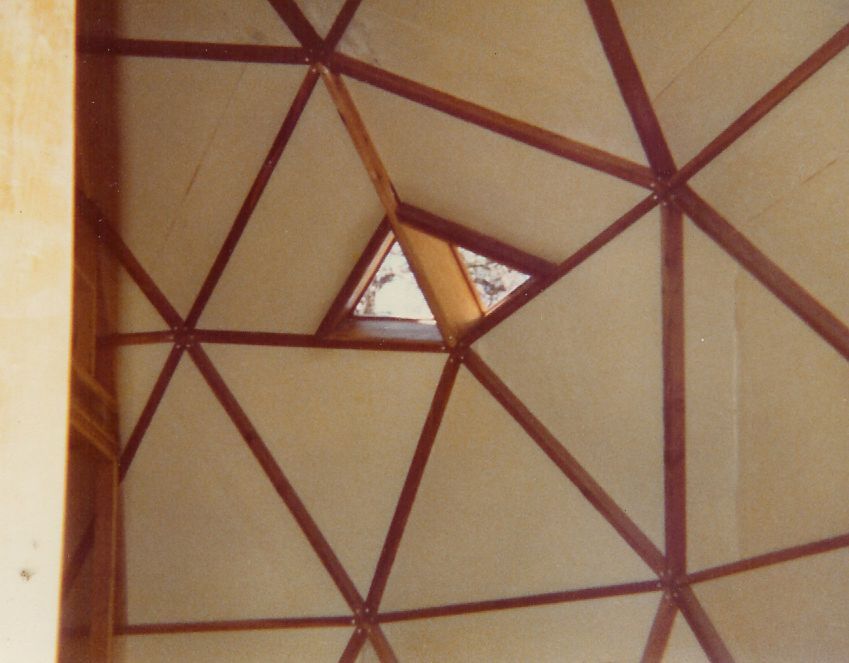 A ceiling with a window in the middle of it
