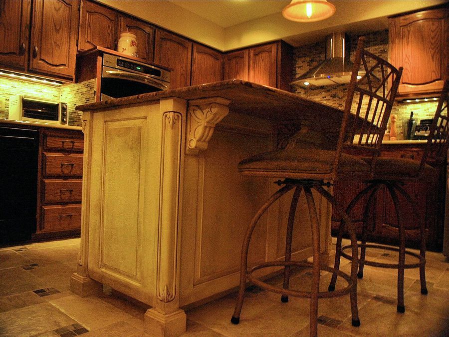 A kitchen with a large island and stools