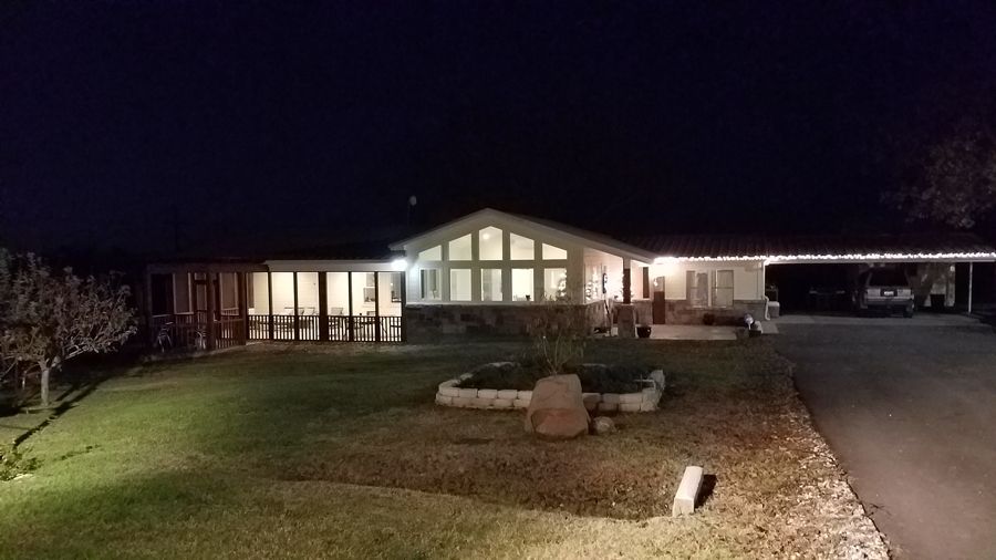 A mobile home is lit up at night with a lot of windows.