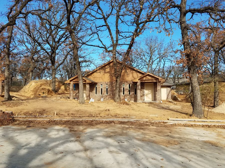 A small house is being built in the middle of a forest.