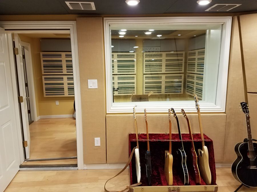 A room with a lot of guitars in it