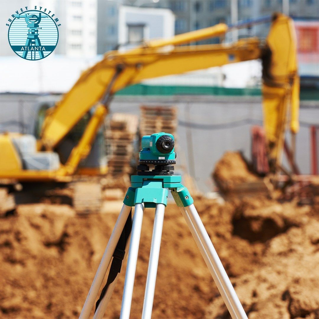 A construction site with a yellow excavator in the background.